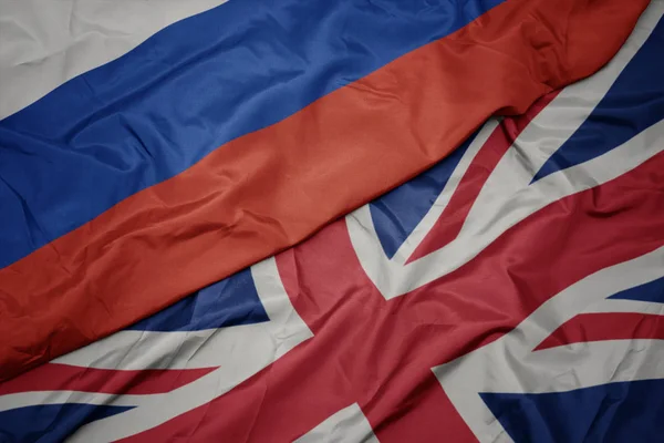 Acenando bandeira colorida de grande Grã-Bretanha e bandeira nacional da Rússia . — Fotografia de Stock