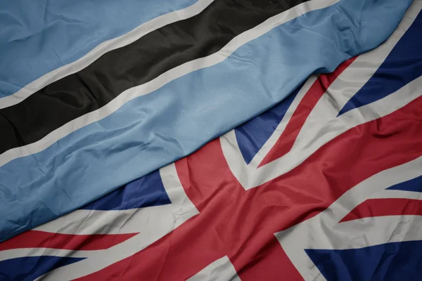 Waving colorful flag of great britain and national flag of botswana. — Stock Photo, Image