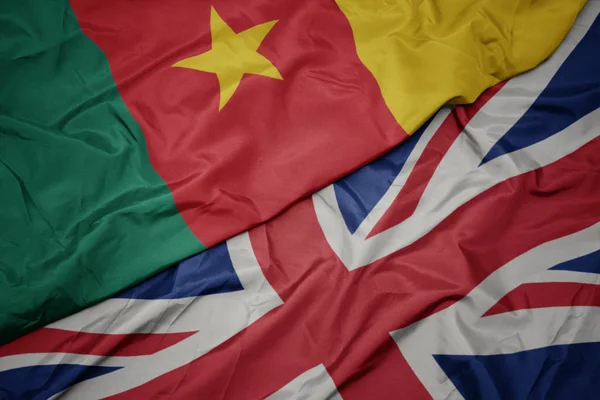 Waving colorful flag of great britain and national flag of cameroon. — Stock Photo, Image