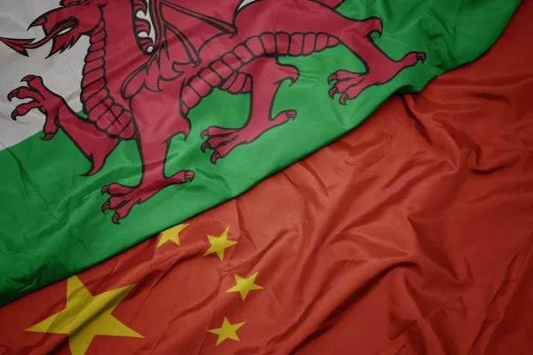 Waving colorful flag of china and national flag of wales. — Stock Photo, Image