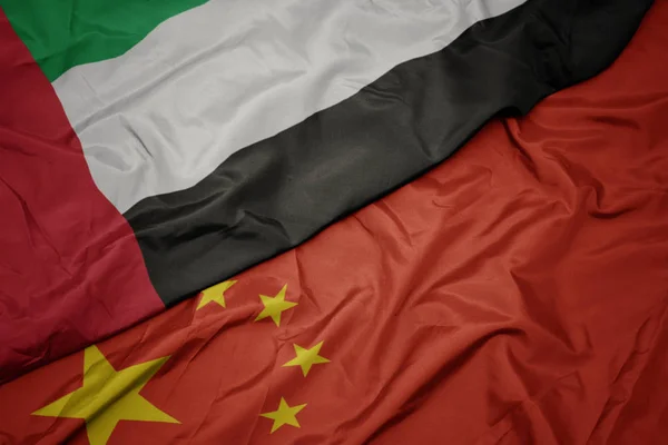 Waving colorful flag of china and national flag of united arab emirates. — Stock Photo, Image