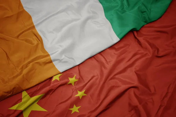 Waving colorful flag of china and national flag of cote divoire. — Stock Photo, Image