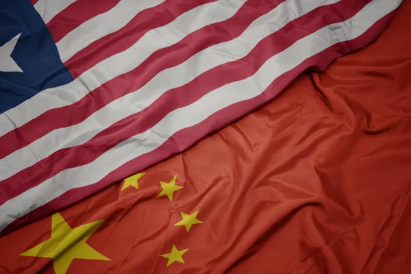 Waving colorful flag of china and national flag of liberia. — Stock Photo, Image