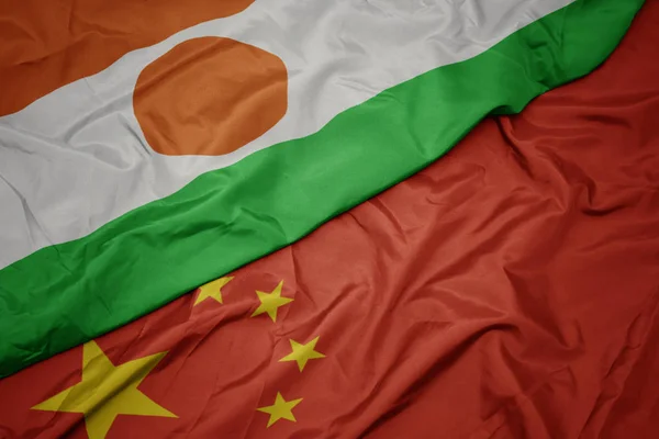 Waving colorful flag of china and national flag of niger. — Stock Photo, Image