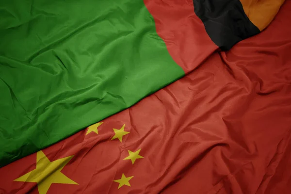 Ondeando colorida bandera de China y bandera nacional de zambia . — Foto de Stock