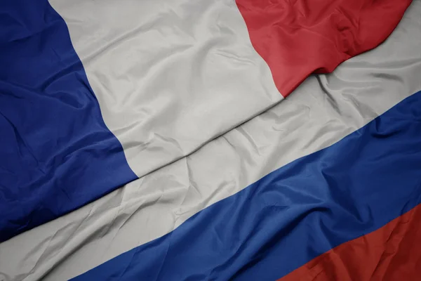 Waving colorful flag of russia and national flag of france. — Stock Photo, Image