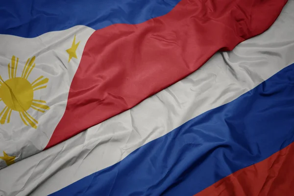 Waving colorful flag of russia and national flag of philippines. — Stock Photo, Image