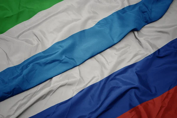 Waving colorful flag of russia and national flag of sierra leone. — Stock Photo, Image