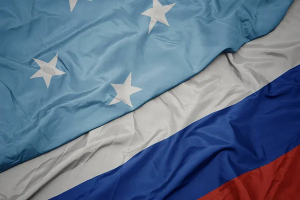 Waving colorful flag of russia and national flag of Federated States of Micronesia. — Stock Photo, Image