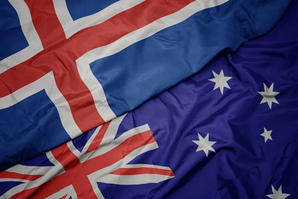 Acenando bandeira colorida da Austrália e bandeira nacional da Islândia . — Fotografia de Stock