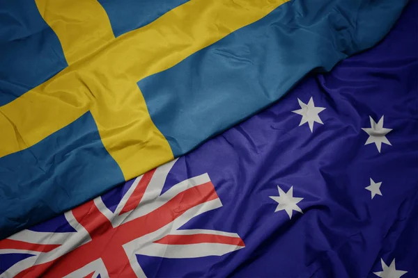 Sventolando bandiera colorata dell'Australia e bandiera nazionale dello Svezia . — Foto Stock