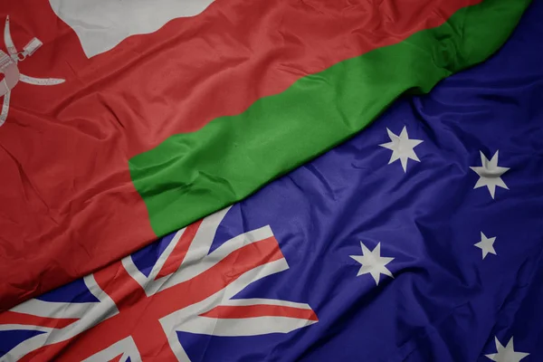 オーストラリアのカラフルな旗とオマーンの国旗を振る. — ストック写真