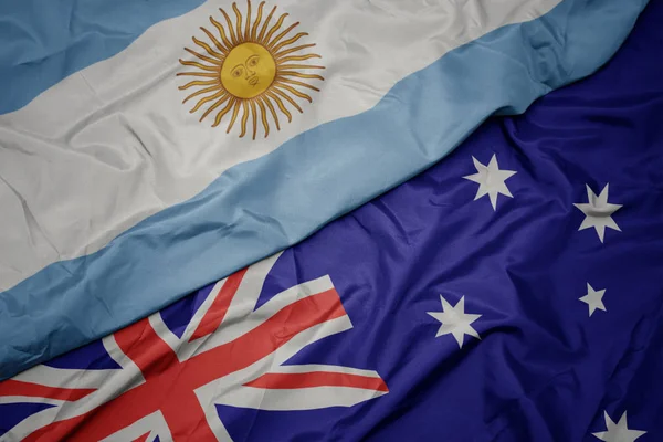 Ondeando colorida bandera de Australia y bandera nacional de Argentina . —  Fotos de Stock