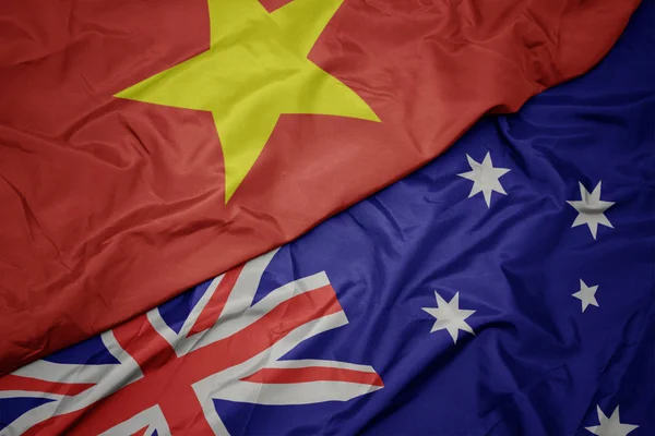 オーストラリアのカラフルな旗とベトナムの国旗を振る. — ストック写真