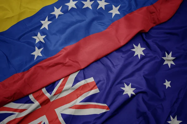 Schwenken bunte Flagge Australiens und Nationalflagge Venezuelas. — Stockfoto