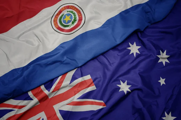 Waving colorful flag of australia and national flag of paraguay. — Stock Photo, Image