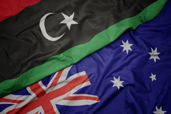 Waving colorful flag of australia and national flag of libya. — Stock Photo, Image