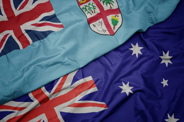 Waving colorful flag of australia and national flag of Fiji. — Stock Photo, Image