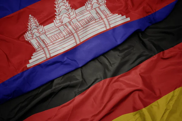 Ondeando colorida bandera de Alemania y bandera nacional de Camboya . —  Fotos de Stock