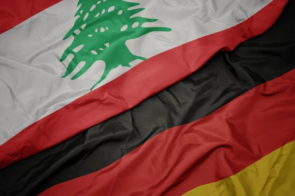 Waving colorful flag of germany and national flag of lebanon. — Stock Photo, Image