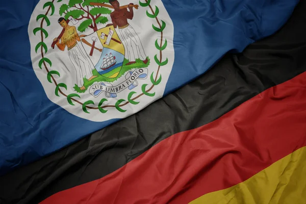 ドイツのカラフルな旗とベリーズの国旗を振る. — ストック写真