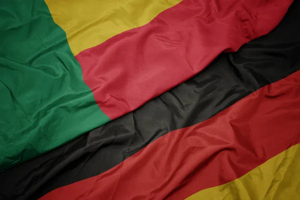 Waving colorful flag of germany and national flag of benin. — Stock Photo, Image