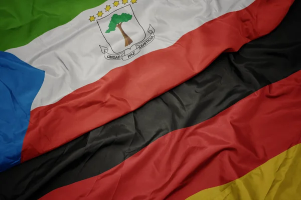 Ondeando colorida bandera de Alemania y bandera nacional de Guinea Ecuatorial . —  Fotos de Stock
