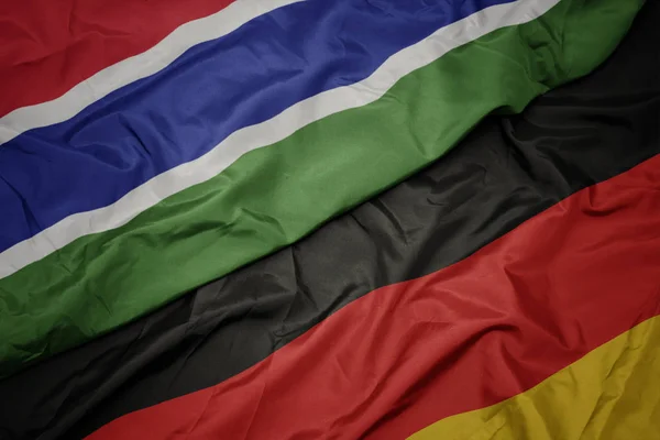 ドイツのカラフルな旗とガンビアの国旗を振る. — ストック写真
