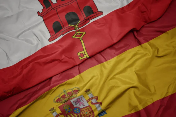 İspanya ve cebelitarık ulusal bayrağı renkli bayrak sallayarak. — Stok fotoğraf