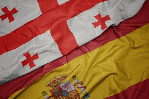 挥舞着五颜六色的西班牙国旗和格鲁吉亚国旗. — 图库照片