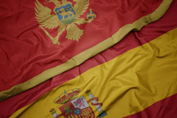 Waving colorful flag of spain and national flag of montenegro. — Stock Photo, Image
