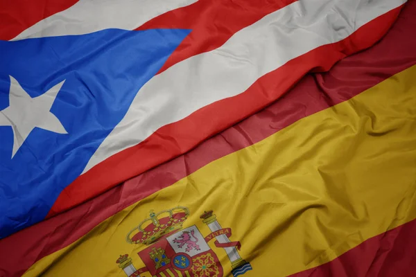 Waving colorful flag of spain and national flag of puerto rico. — Stock Photo, Image