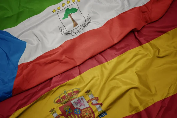 İspanya ve ekvator ginesi ulusal bayrağı renkli bayrak sallayarak. — Stok fotoğraf