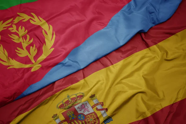 Waving colorful flag of spain and national flag of eritrea. — Stock Photo, Image