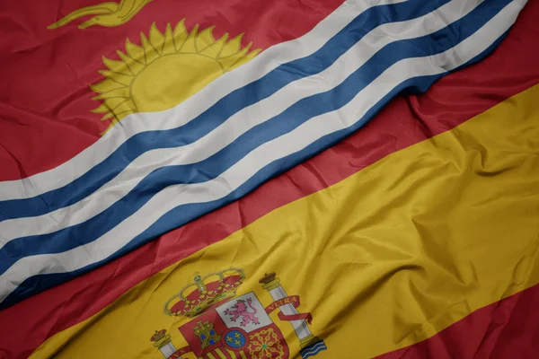 挥舞着五颜六色的西班牙国旗和基里巴斯国旗. — 图库照片
