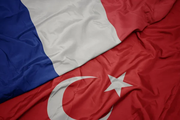 Waving colorful flag of turkey and national flag of france. — Stock Photo, Image