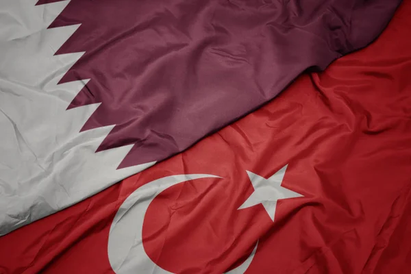 Waving colorful flag of turkey and national flag of qatar. — Stock Photo, Image