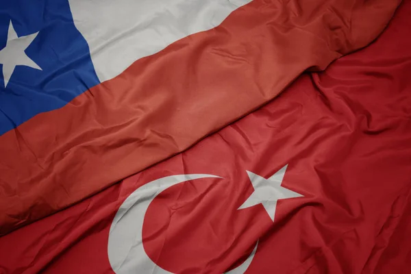 Waving colorful flag of turkey and national flag of chile. — Stock Photo, Image