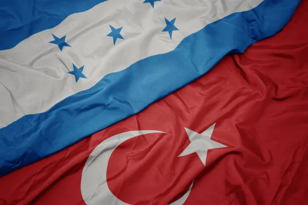 Waving colorful flag of turkey and national flag of honduras. — Stock Photo, Image