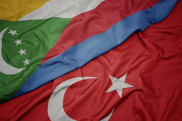 Waving colorful flag of turkey and national flag of comoros. — Stock Photo, Image