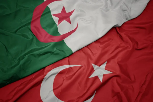 Waving colorful flag of turkey and national flag of algeria. — Stock Photo, Image