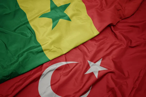 Waving colorful flag of turkey and national flag of senegal. — Stock Photo, Image