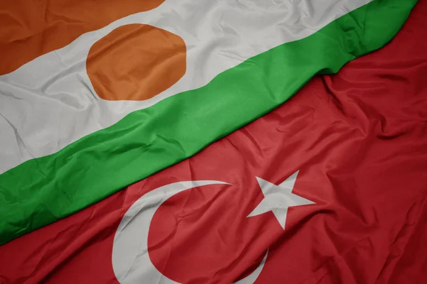 Waving colorful flag of turkey and national flag of niger. — Stock Photo, Image