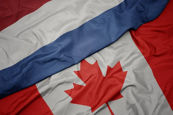 Waving colorful flag of canada and national flag of netherlands. — Stock Photo, Image