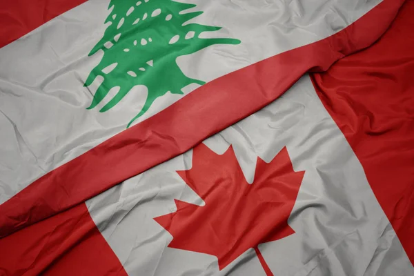 Waving colorful flag of canada and national flag of lebanon. — Stock Photo, Image