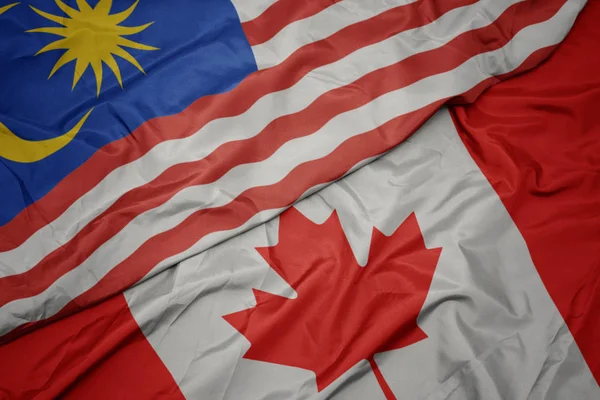 Waving colorful flag of canada and national flag of malaysia. — Stock Photo, Image