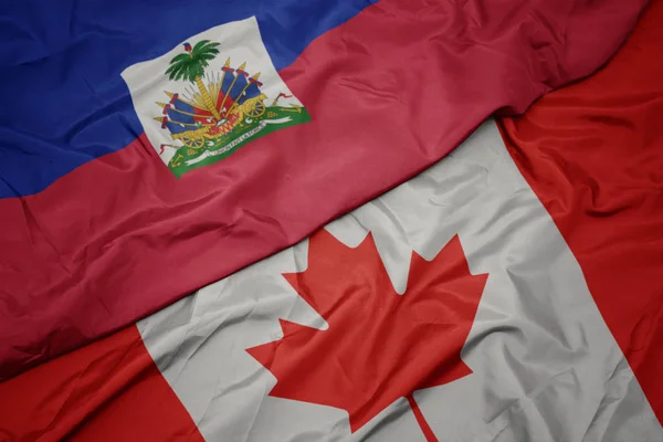 Ondeando colorida bandera de canada y bandera nacional de haiti . —  Fotos de Stock