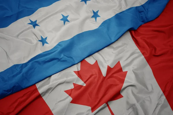 カナダのカラフルな旗とホンジュラスの国旗を振る. — ストック写真
