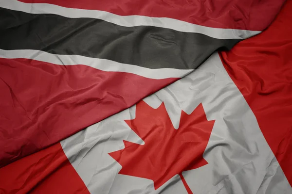 Vifta färgglada flagga Kanada och nationella flaggan i Trinidad och Tobago. — Stockfoto