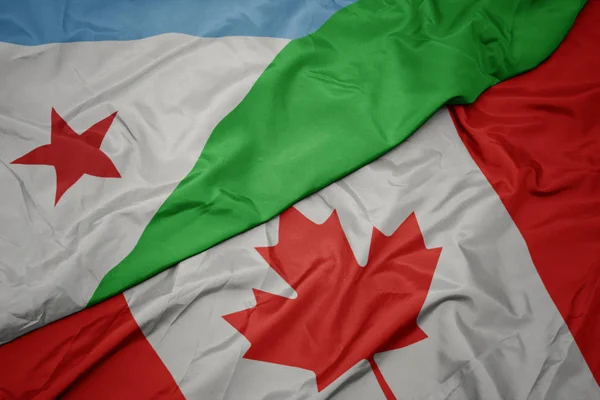 Ondeando colorida bandera de canada y bandera nacional de djibouti . —  Fotos de Stock